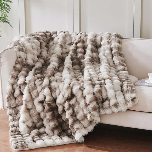 100% polyester construction with reversible faux fur front and sherpa fleece back