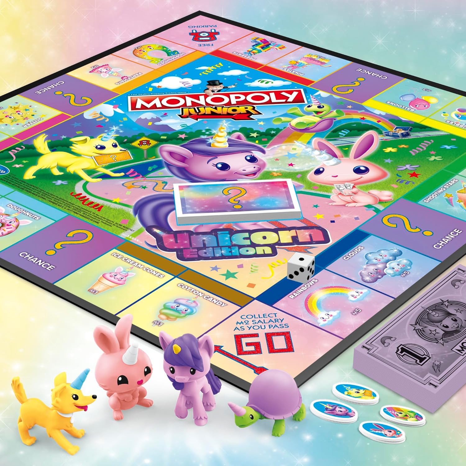 colorful unicorn-world gameboard featuring rainbows, butterflies, shooting stars, cupcakes, and presents