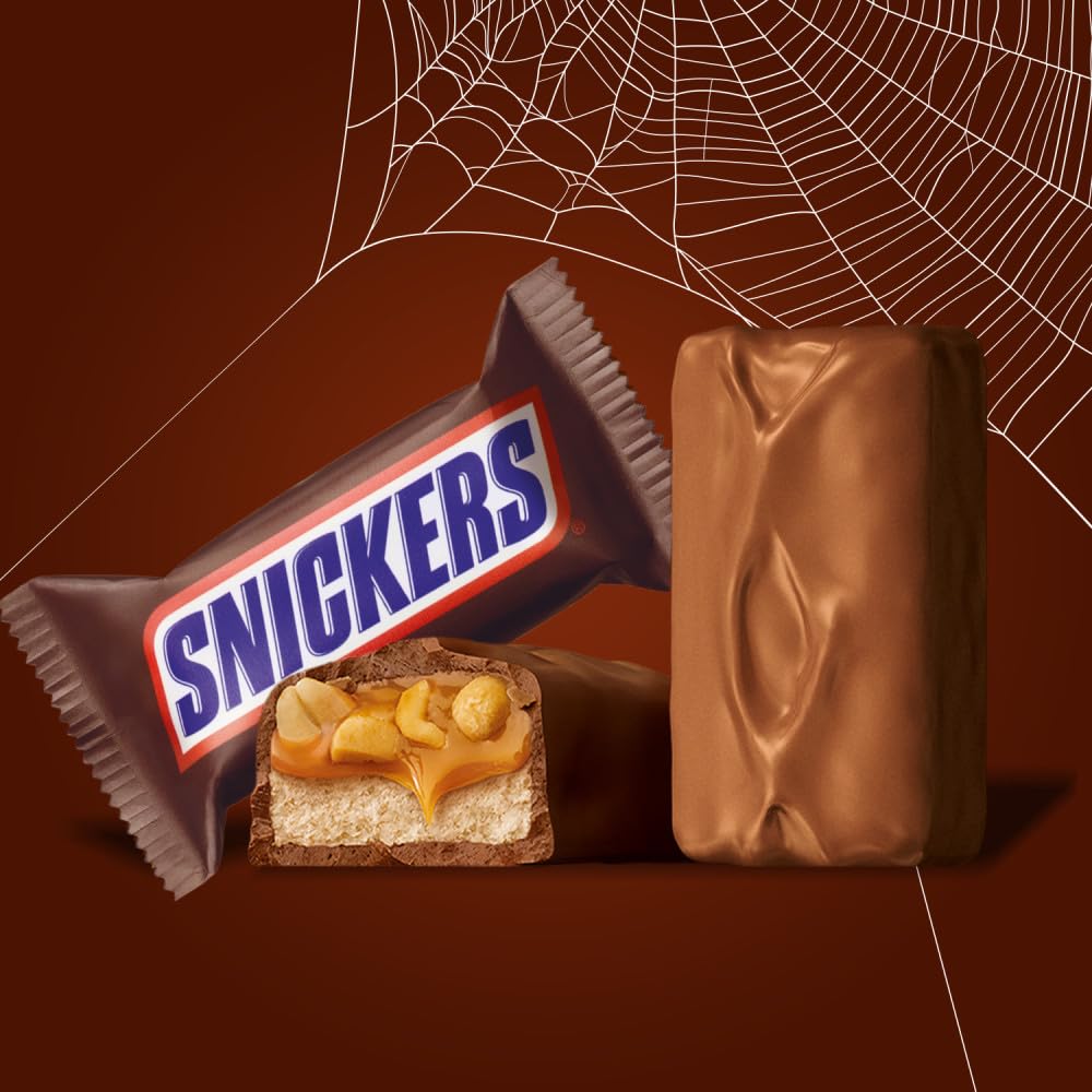 composition of milk chocolate, caramel, nougat, and roasted peanuts