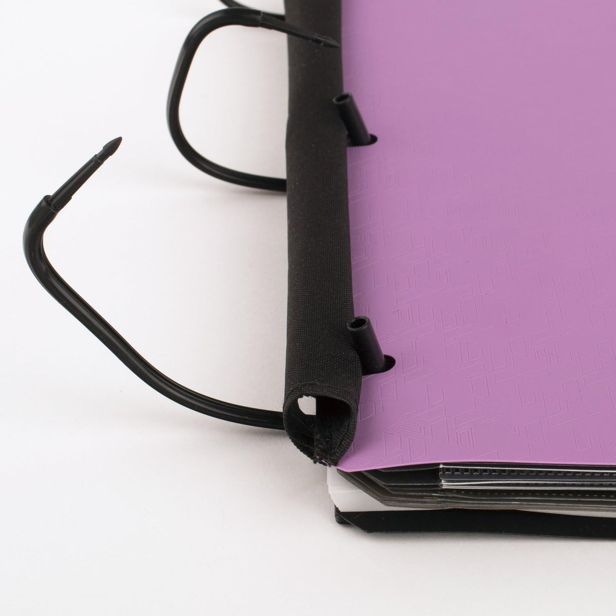 flexible plastic cover that folds back over the rings to lie flat like a traditional notebook
