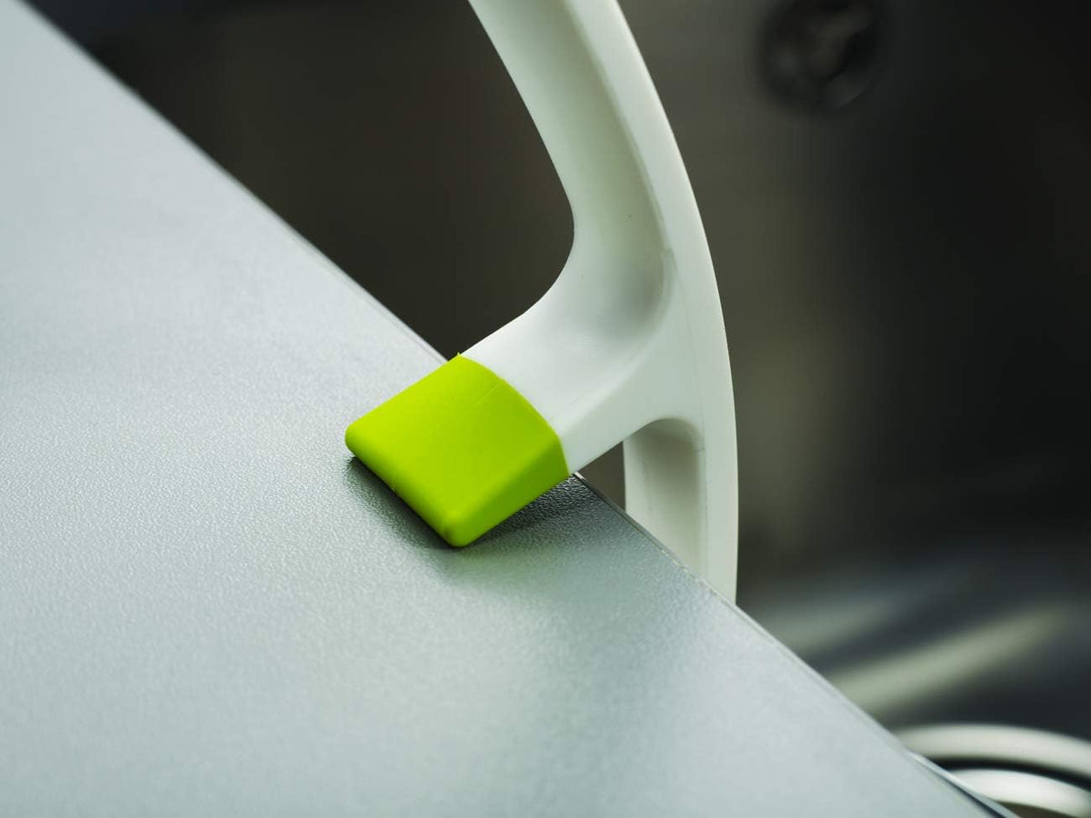 integrated pan scraper edge for removing tough, baked-on food deposits