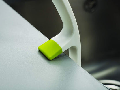 integrated pan scraper edge for removing tough, baked-on food deposits