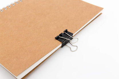 spring-tight tension mechanism for secure grip on thick paper stacks
